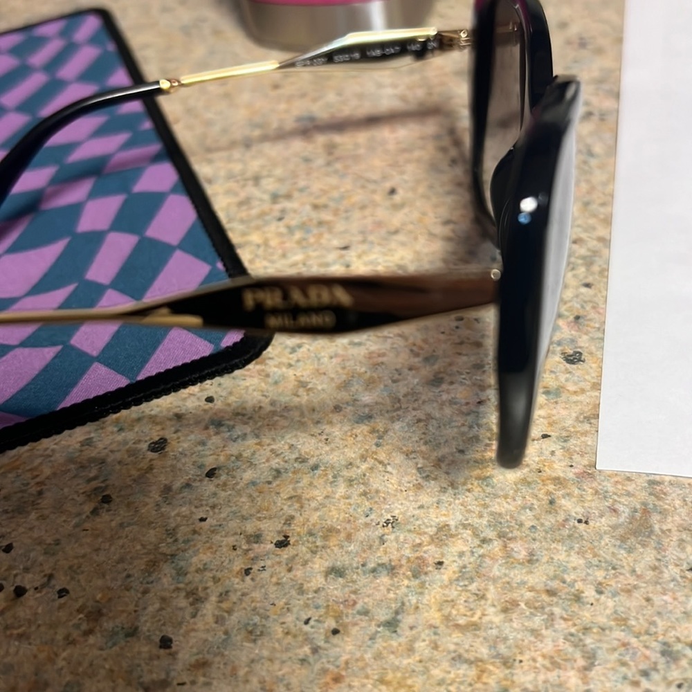 Minimal Prada used women glasses.